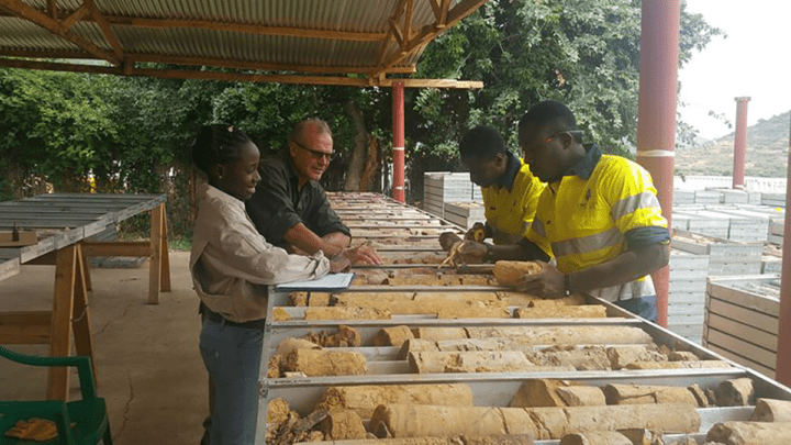 Men sorting bulker bags of ore samples at a Tanzanian gold project