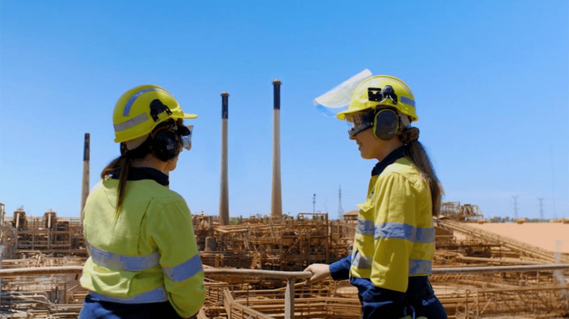 Two women overlooking Alcoa's Kwinana alumina refinery in Western Australia.
